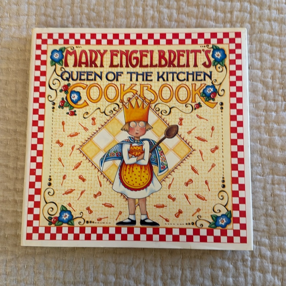 Mary Engelbreit‘s queen of the kitchen cookbook. New with book cover.